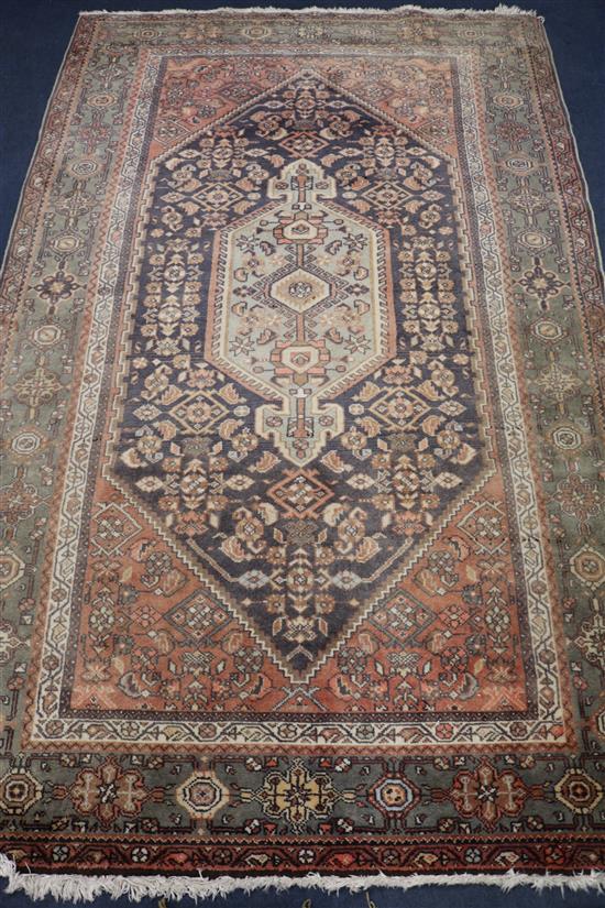 An Iranian red ground rug, 7ft 3in. x 4ft 10in.